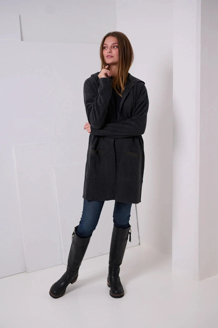The HENRIETTE STEFFENSEN FLEECE HOODED CARDIGAN by HENRIETTE STEFFENSEN features a black, open-front design with long sleeves and a relaxed fit, crafted from Oeko-Tex certified fleece for both comfort and sustainability. Shown on a plain white background, it’s the ideal choice for everyday wear.