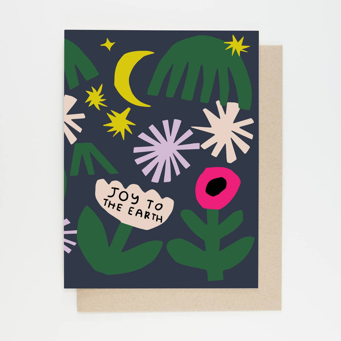 Greeting card front with green foliage, yellow moon, white burst snowflakes, and bright pink circle.