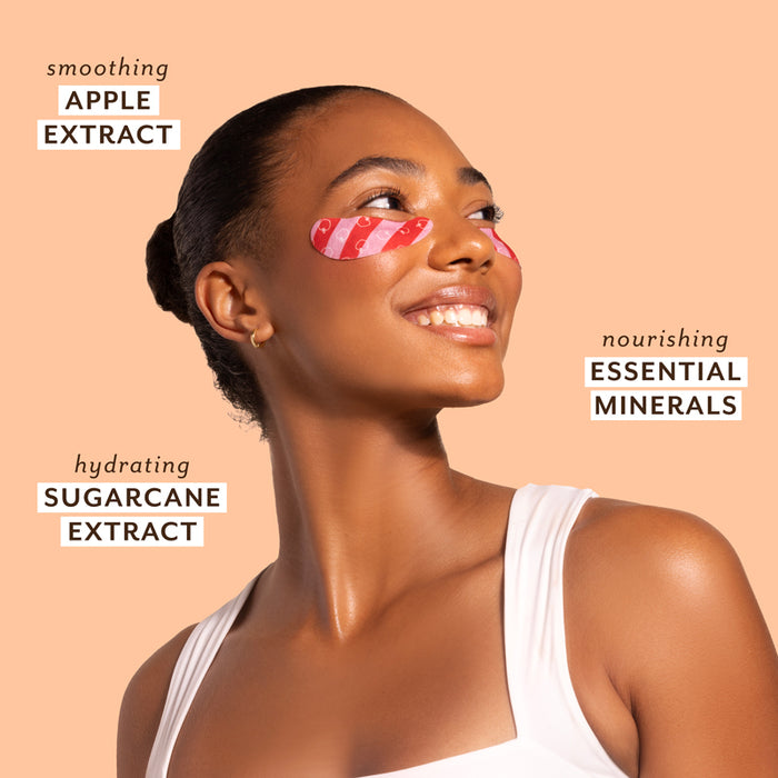 Woman with pink eye patches on a beige background with text about skincare ingredients.