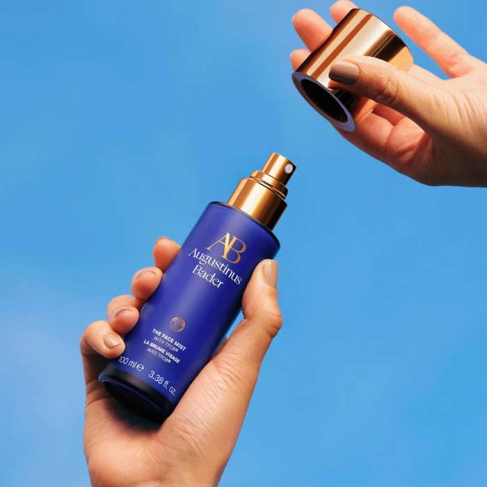 Augustinus Bader The Face Mist blue bottle with gold spray cap in hand, TFC8 hydrating mist