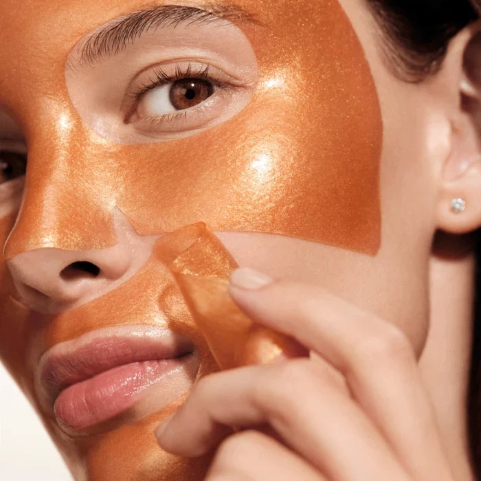 Woman applying Augustinus Bader hydrogel face mask for hydrated, plump skin