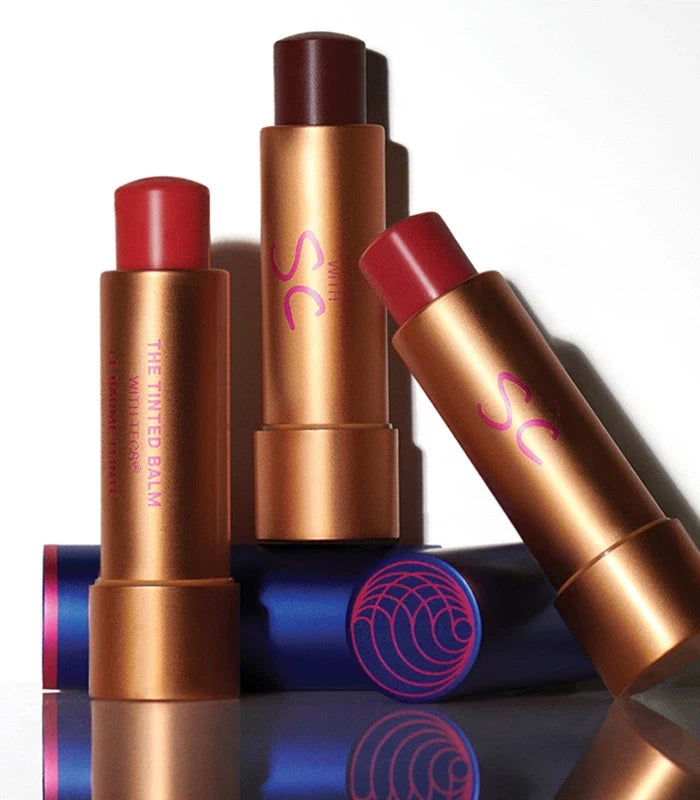 Augustinus Bader The Tinted Balm lip balm sticks in copper and red shades