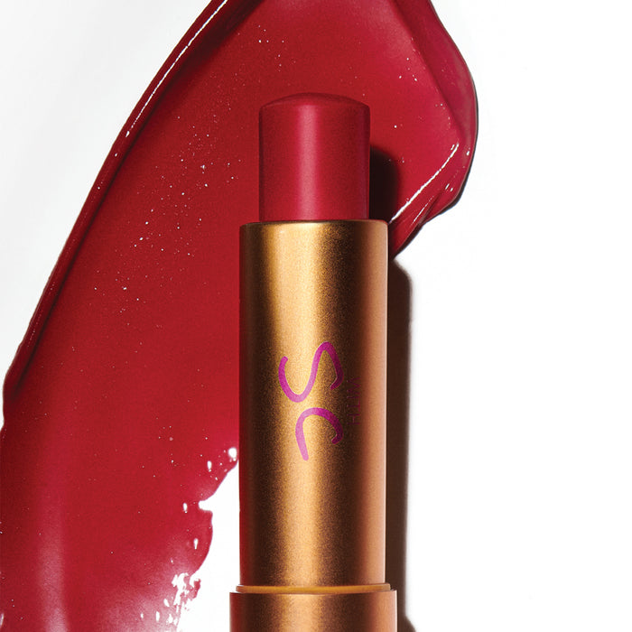 Augustinus Bader The Tinted Balm in bronze tube with deep red balm swatch