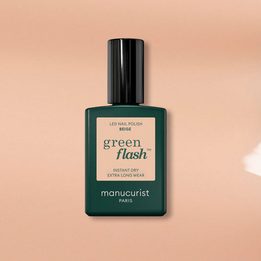 Manucurist's Beige Green Flash gel nail polish features a dark green cap and label, shown against a beige background—ideal for achieving a nude gel look.