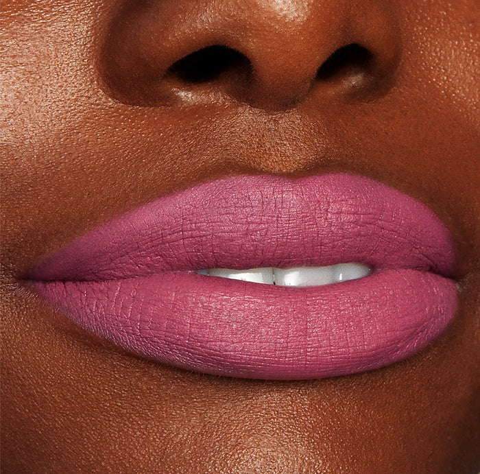 Byron Babe ColourPop Lippie Stix coating lips in a matte mauve‑pink, delivering full‑coverage color with a soft‑focus finish, shown in a close-up beauty shot highlighting smooth texture and precise edges.
