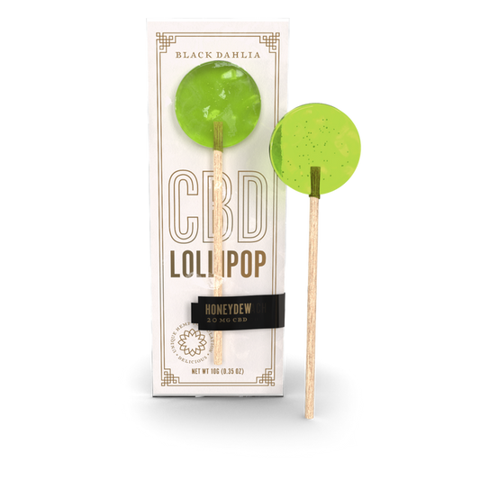 Honeydew CBD lollipop with green hard candy on a wooden stick