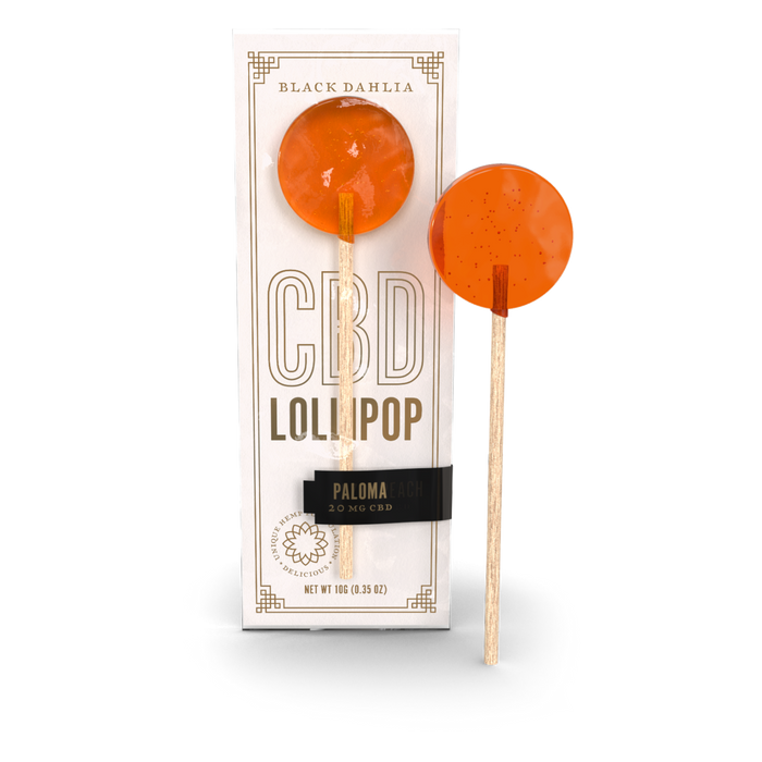 Paloma CBD lollipop, orange hard candy on a stick, shown with box