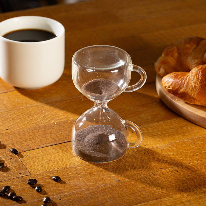 Glass hourglass sand timer with brown coffee sand and mug-shaped side handles
