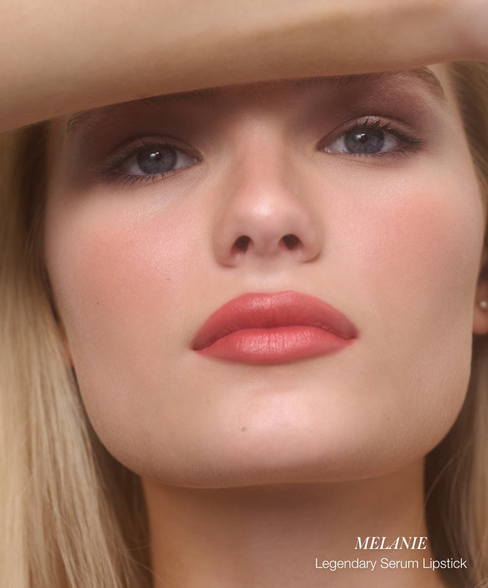 Close-up of a woman with natural makeup wearing smooth, vibrant coral-pink lipstick highlighting lips in a clean beauty style showcasing Color Capsule: Strawberry Matcha.