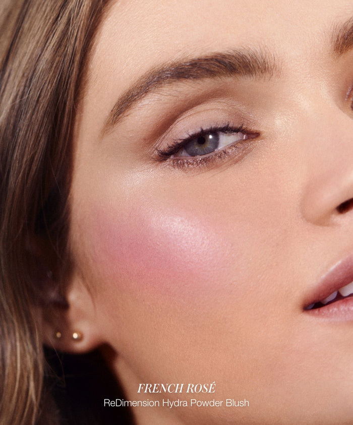 Close-up of a woman’s face showcasing a soft pink blush on her cheek, highlighting natural beauty with clean ingredients from Color Capsule: The Rosé Edit.