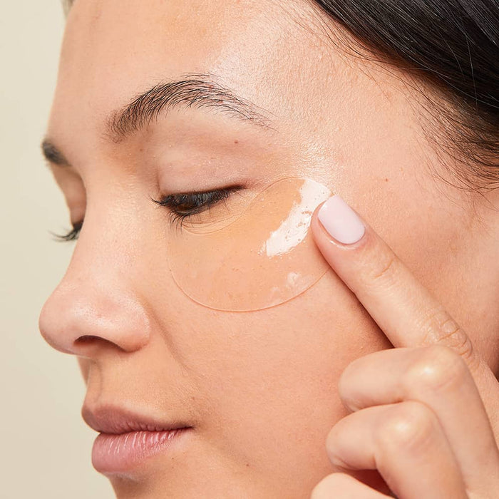 Woman wearing bubbly eye gels to remove puffiness and wrinkles