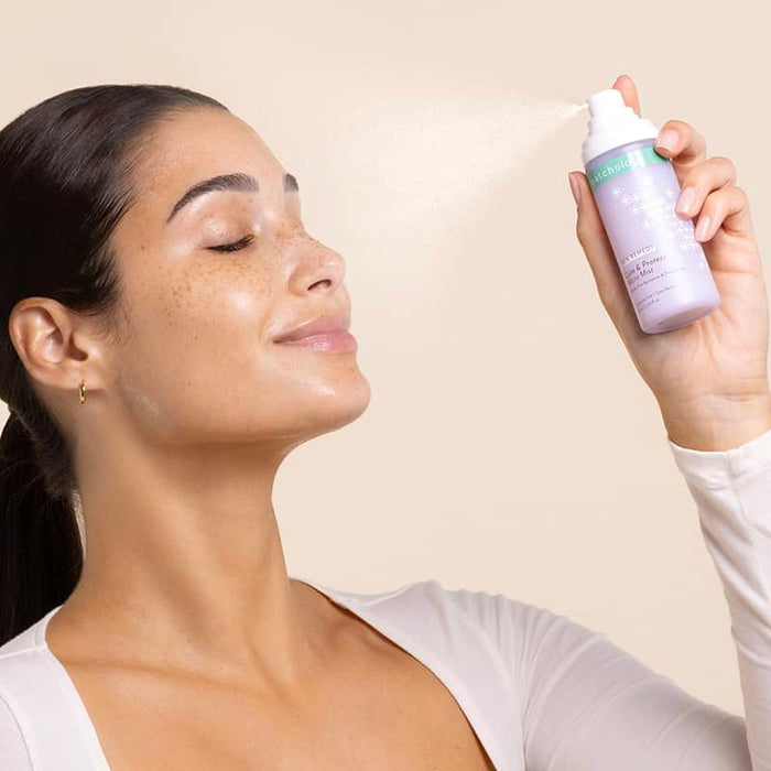 Skin remedy face mist in use woman spraying blue light protection and hydrating mist on a tan background
