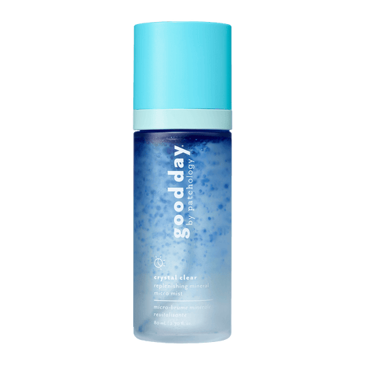 A bottle of Good Day Crystal Clear Refreshing Mineral Micra Mist, featuring a light blue cap and a blue-to-clear gradient bottle, centered on a solid green background.