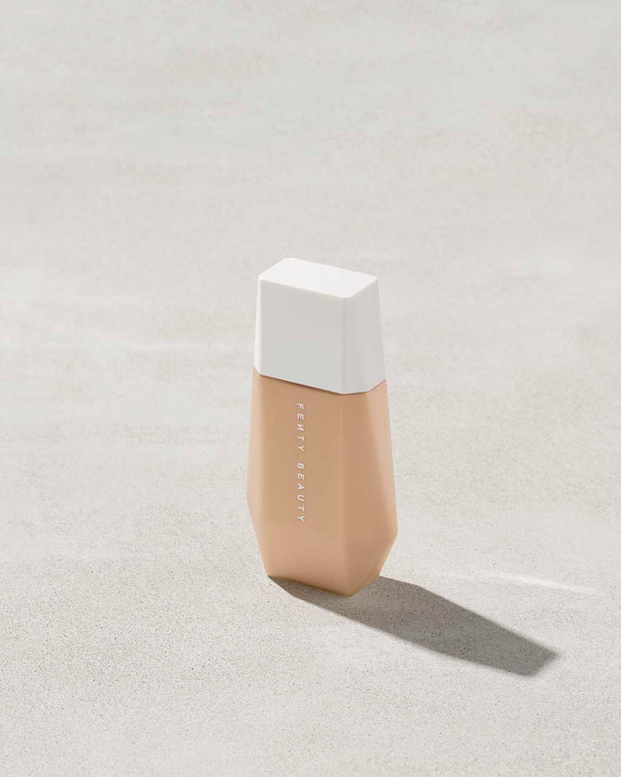 A bottle of Eaze Drop Blurring Skin Tint in shade 8 on a grey backdrop.