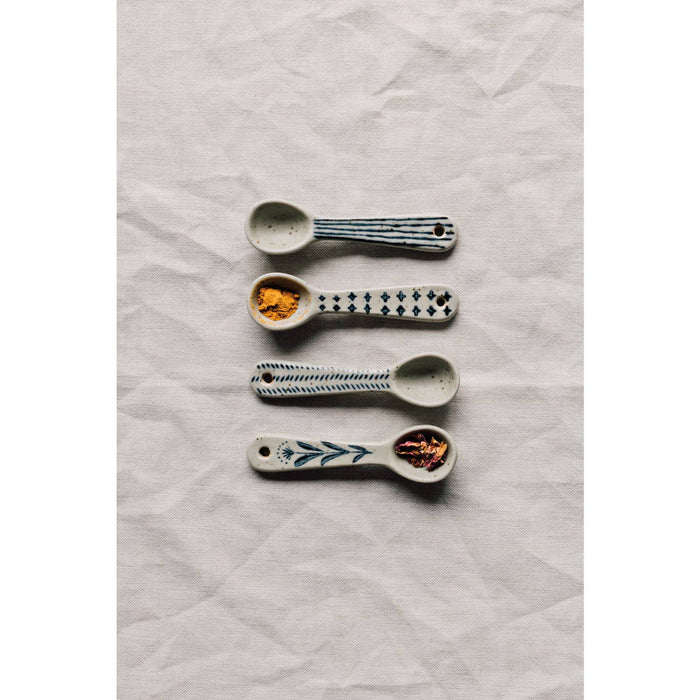 Mini spoon assortment with four small spoons, blue motifs, speckled bowls, and end holes