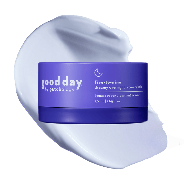 A purple cosmetic jar labeled 'good day by patchology five-to-nine dreamy overnight recovery balm' placed on top of a white cream smear against a solid black background.