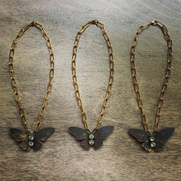 Chasing Cherubs Flutter necklace featuring a delicate gold chain with a small, elegant pendant design.
