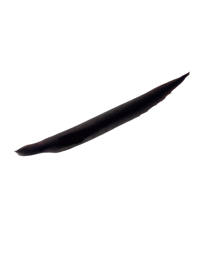A thick swatch of Flyliner Longwear Liquid Eyeliner in the color "Cuz I'm Black", showcasing its satin black finish, boldly contrasted against a pristine white background.