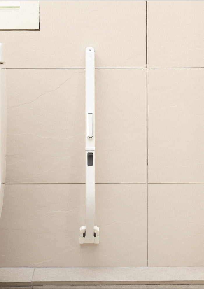 White kitchen cabinet handle on a beige cabinet