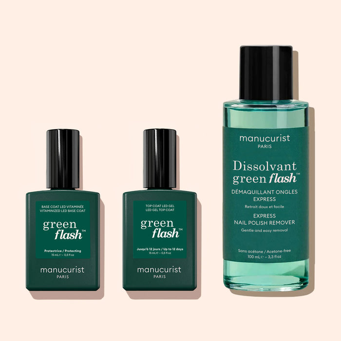 Three green Manucurist bottles: two Green Flash™ Top Coat gel polish bottles with black caps and 12-day shine, plus one larger Dissolvant remover bottle with a black cap and turquoise liquid, all on a beige background.