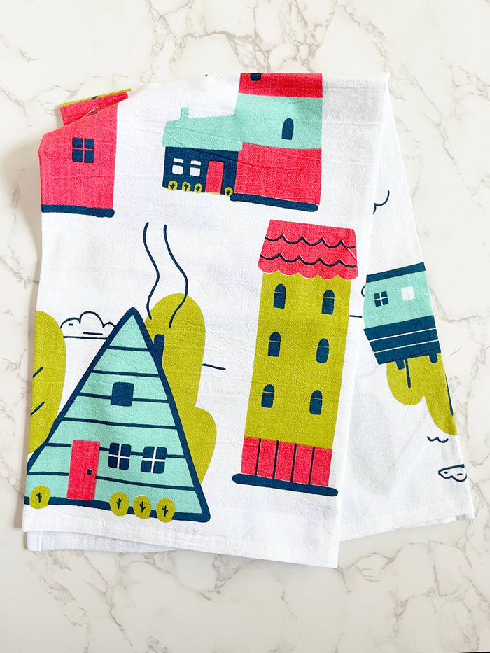 Illustrated abstract homes on a kitchen towel, featuring colorful house designs by The Coin Laundry for house-themed decor.