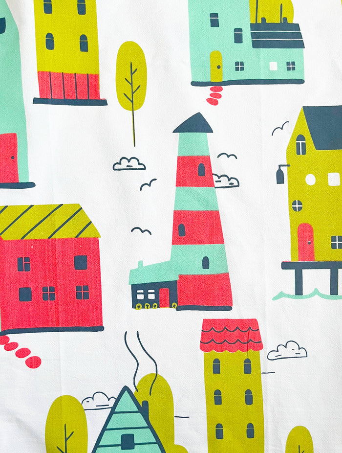 Houses illustrated abstract design on The Coin Laundry kitchen towel, featuring colorful, artistic home imagery for kitchen decor.