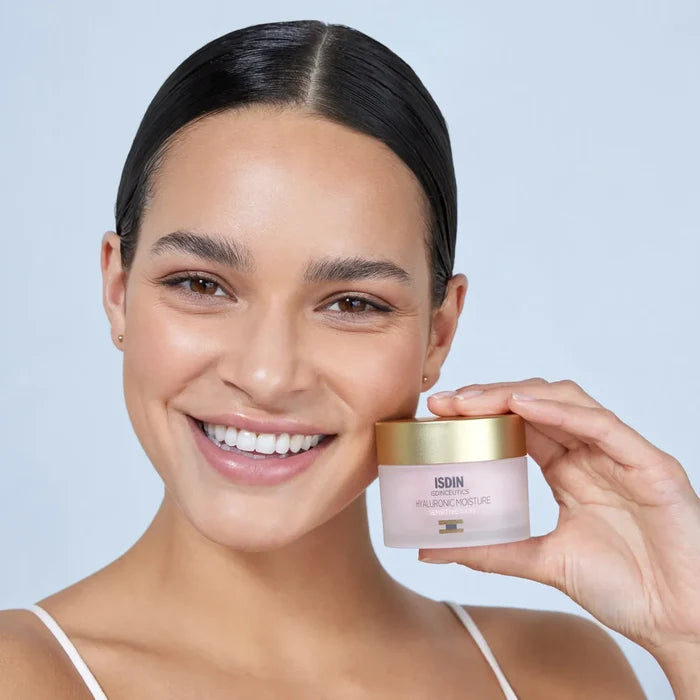 Woman holding ISDIN Isdinceutics Hyaluronic Moisture Sensitive Skin moisturizer jar