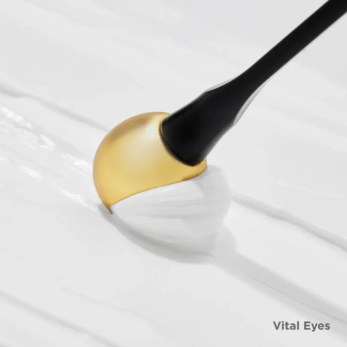 Vital Eyes eye cream texture with gold-and-white formula and applicator