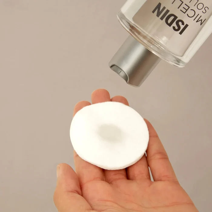ISDIN Micellar Solution bottle dispensing onto cotton pad