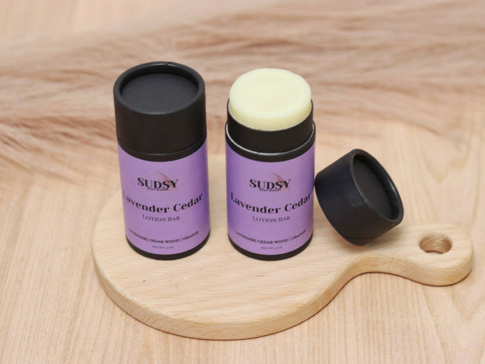 Lavender and cedar natural lotion bar by Sudsy Soap Works LLC, showing a solid moisturizer with lavender and cedar scent.
