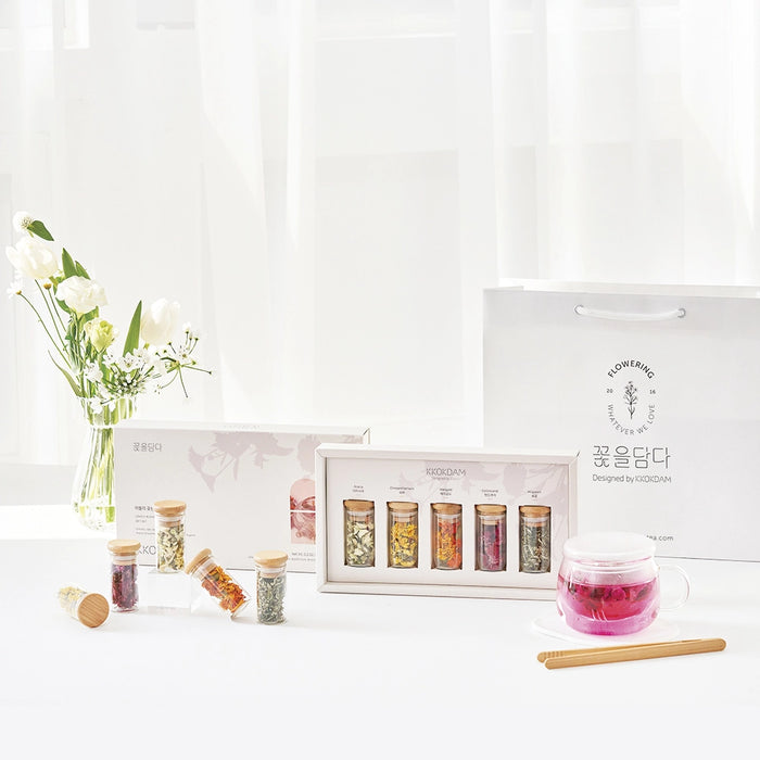 Flower tea gift set with pink glass tea cup, wooden stirrer, and boxed jar assortment