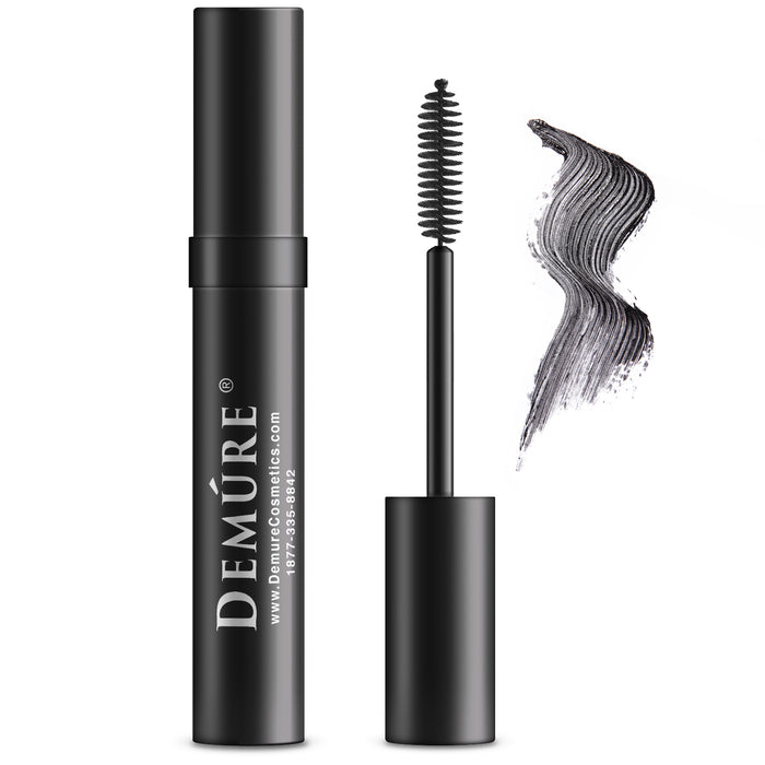 Tube of Demure  Black Mascara with the applicator and a swatch