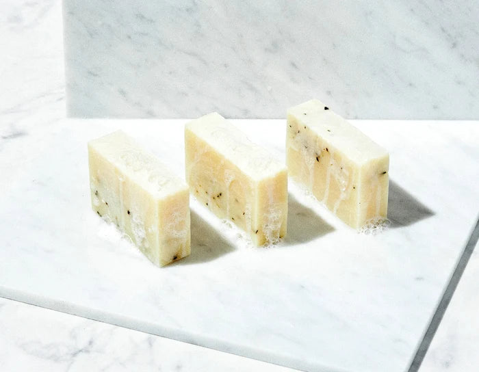 natural handmade soap bars on white marble surface