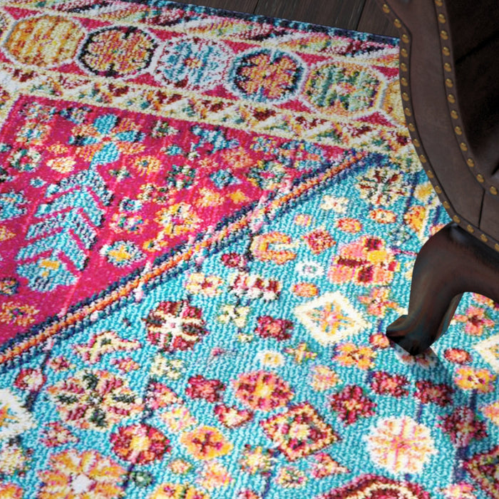 Colorful floral-patterned rug with a chair partially visible