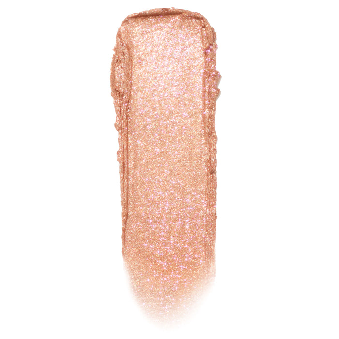 Shimmering rose‑gold peach swipe with fine pink sparkle shows Mystical Jelly Much Shadow texture on a white background, highlighting its glossy-to-metallic payoff; ColourPop Jelly Much Shadow single eyeshadow swatch.