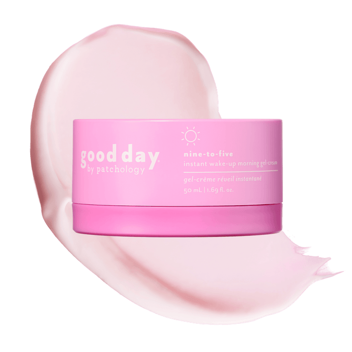 A pink cosmetic jar labeled 'good day' nine-to-five placed over a large pale pink cream smear on a black background.