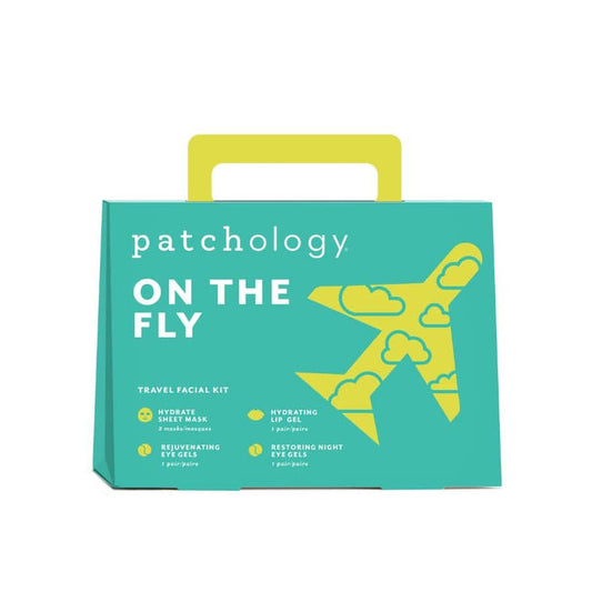 On The Fly travel skincare kit in teal packaging with yellow handle and plane graphic.