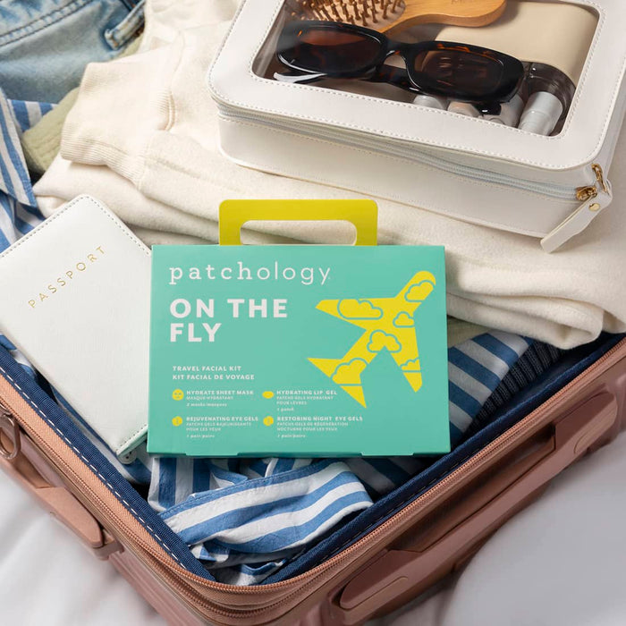 Patchology “On The Fly” travel facial kit in suitcase with skincare essentials, perfect for hydrating, refreshing, and revitalizing skin on the go