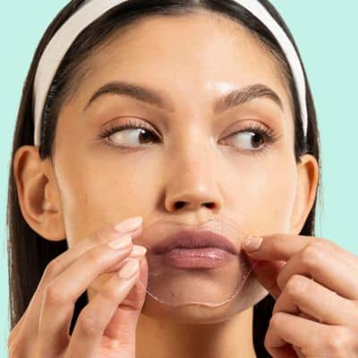 woman wearing hydrating lip gels to smooth and firm fine lines around your mouth and lips