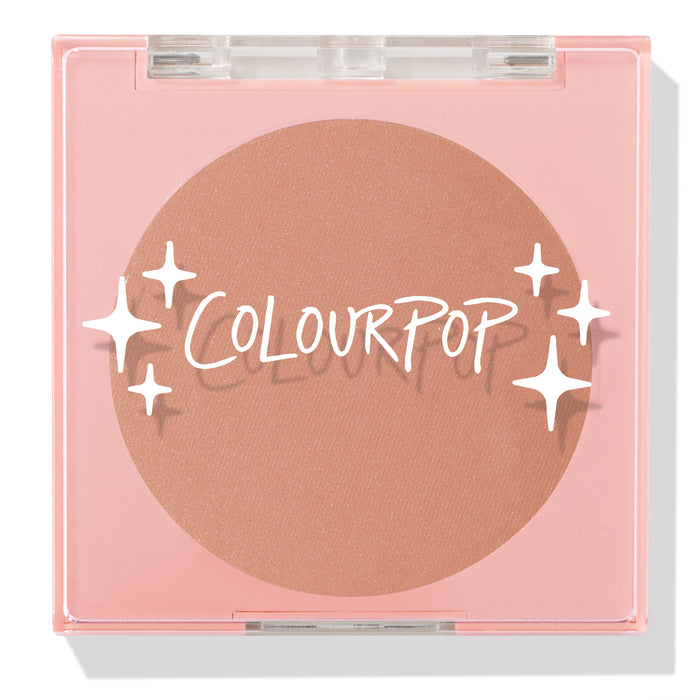 ColourPop Pressed Powder Blush Out & About shown closed, a soft peach blush in a pink square compact with a clear lid, white star graphics, and ColourPop logo, photographed on a white studio background.