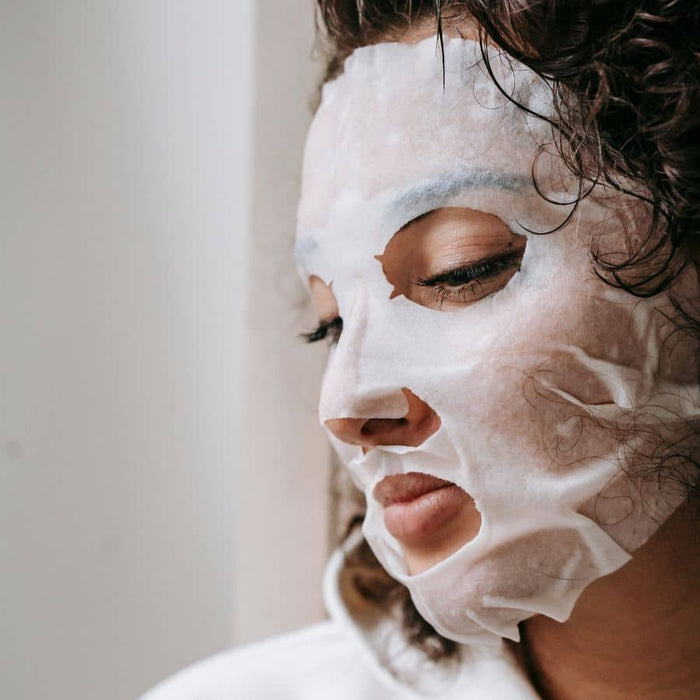 woman wearing playing defense barrier boosting sheet mask