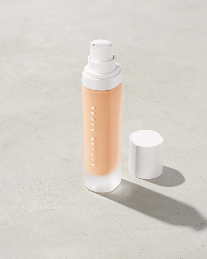 open bottle of Fenty Beauty Pro Filt'r Soft Matte Longwear Foundation with pump dispenser in shade #120 on concrete background
