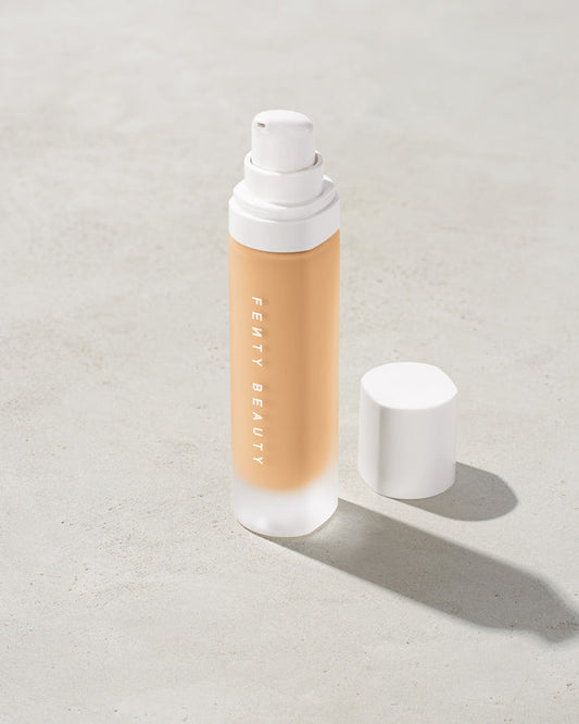 open bottle of Fenty Beauty Pro Filt'r Soft Matte Longwear Foundation with pump dispenser in shade #190 on concrete background