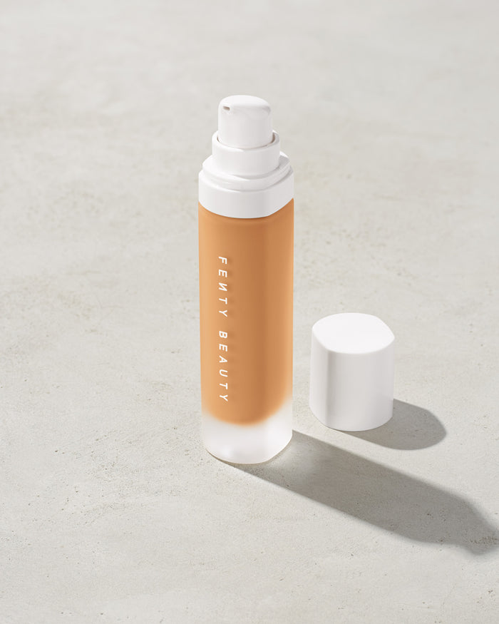 open bottle of Fenty Beauty Pro Filt'r Soft Matte Longwear Foundation with pump dispenser in shade #280 on concrete background