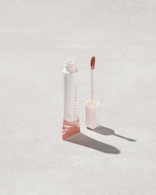 Open tube of Pro Kiss'r Luscious Lip Balm in shade Latte Lips on grey background.