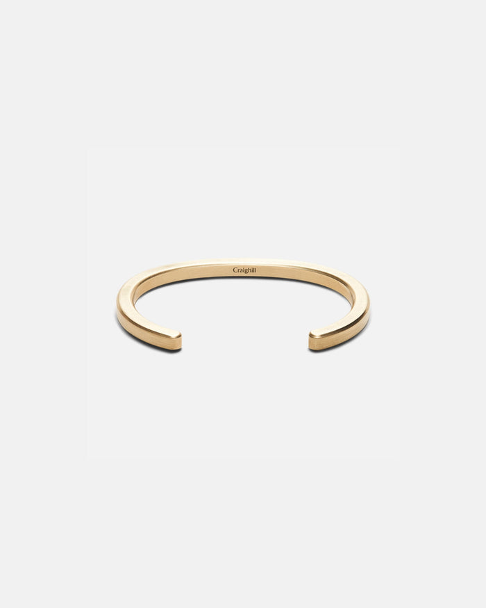 Brass cuff bracelet with open C-shape and radial cutout design