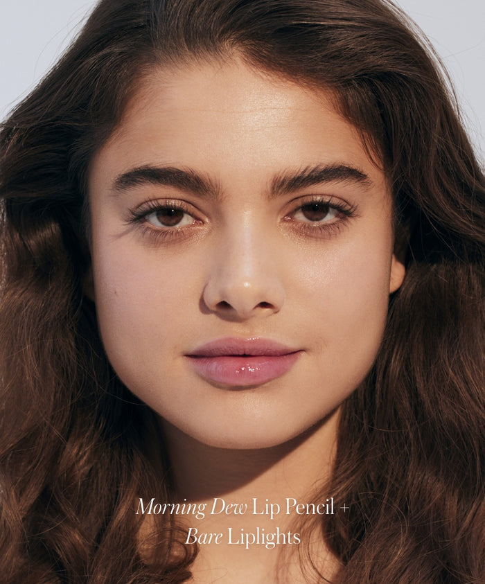 Close-up of a woman with natural makeup showcasing the subtle glow and smooth finish of RMS Discovery Kit's Morning Dew Lip Pencil and Bare Liplights, highlighting clean beauty and natural ingredients.