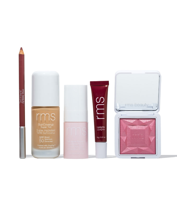 RMS Discovery Kit featuring a lip liner, liquid foundation with SPF 50, a tinted moisturizer, lip gloss, and a pink blush compact, showcasing clean beauty essentials.