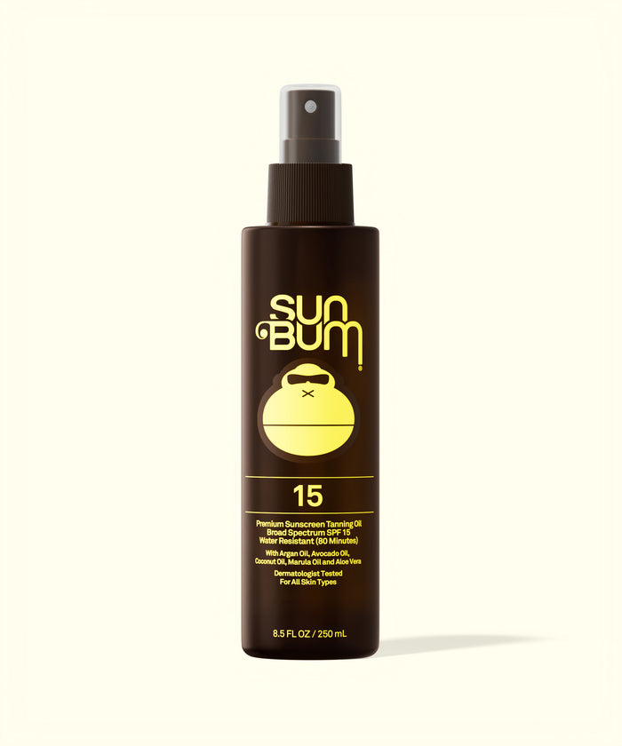 Sun Bum SPF 15 Sunscreen Tanning Oil in a brown spray bottle with yellow logo and text on white background