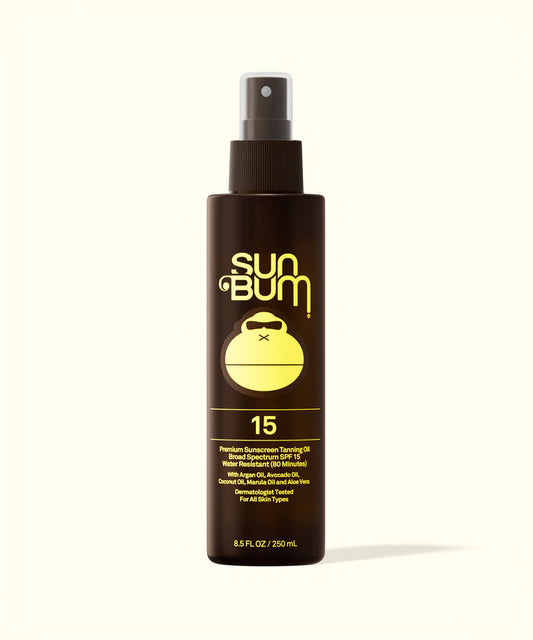Sun Bum SPF 15 Sunscreen Tanning Oil in a brown spray bottle with yellow logo and text on white background